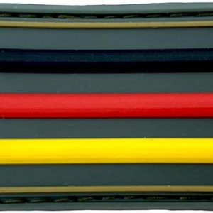 May include: A black, red and yellow German flag patch on a green background. The patch is surrounded by a brown border and has a stitched edge.