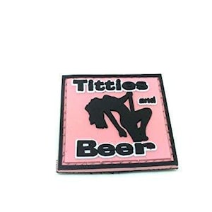 May include: A square patch with a light pink background and a black border. The patch features a black silhouette of a person dancing on a pole in the centre. The text Titties and Beer is printed in bold black letters above and below the figure.