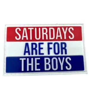 May include: A white patch with red, white and blue stripes. The text "Saturdays Are For The Boys" is printed in white on the patch.