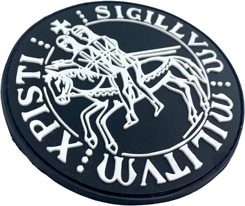 May include: A black and white circular patch with the text "SIGILLVM:WALT:XPI:ST" around the edge. The center of the patch features a white image of three knights riding a horse.