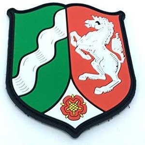May include: A green and red embroidered patch featuring a white unicorn and a white rose with a red centre. The patch is shaped like a shield.