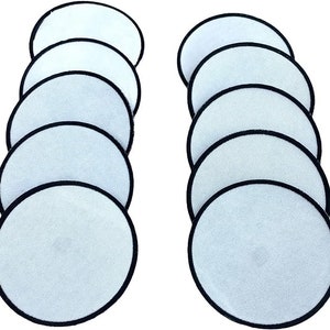 May include: Ten white, round, iron-on patches with black borders. The patches are blank and ready to be customised.