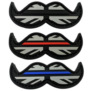 May include: Three black and silver embroidered patches shaped like moustaches. The patches feature a Union Jack design with a thin red line across the top of the middle patch and a thin blue line across the top of the bottom patch.