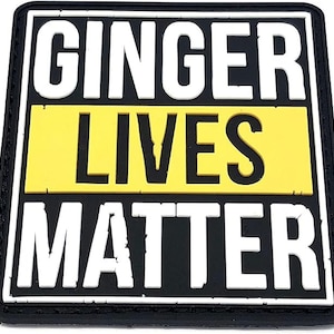 Peut inclure: Écusson noir et jaune avec le texte "Ginger Lives Matter" en lettres blanches.