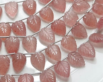 May include: A strand of pink quartz leaf-shaped beads strung on silver wire. The beads are translucent and have a slightly rough texture.