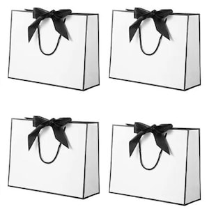 May include: A set of three ceramic mugs with a speckled, matte finish. The mugs are in shades of cream, light gray, and dark gray. Each mug has a simple, minimalist design, perfect for coffee or tea.