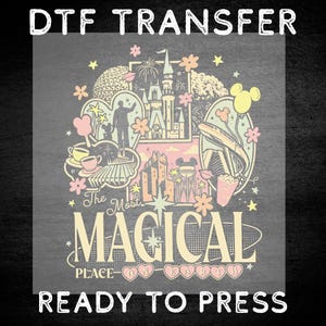 May include: A DTF transfer featuring a pastel-colored graphic with the text "DTF TRANSFER", "The Most MAGICAL PLACE ON EARTH", and "READY TO PRESS". The design includes illustrations of a castle, a monorail, teacups, and stars in pink, yellow, and cream.