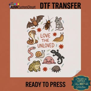May include: A DTF transfer sheet featuring the text LOVE THE UNLOVED surrounded by illustrations of a bat, cockroach, mouse, cobra, slug, worm, snail, lizard, frog, blobfish, and spider. The design includes red star accents on a white background.