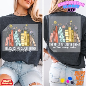 May include: Dark gray sweatshirt with a colorful graphic of stacked books and flowers. The text "THERE IS NO SUCH THING as too many books" is printed below the illustration. The sweatshirt is a ready-to-press item.