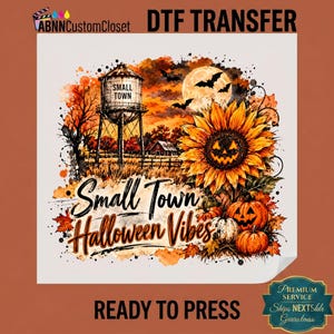 May include: A DTF transfer sheet featuring a watercolor-style Halloween scene with a water tower labeled Small Town, a full moon with bats, a jack-o'-lantern sunflower, and pumpkins. The text reads Small Town Halloween Vibes in black script.
