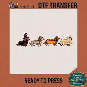 May include: A DTF transfer sheet featuring four dachshunds in Halloween costumes: one as a witch with a black hat and cape, one wrapped as a mummy, one dressed as a hot dog, and one wearing a white ghost sheet. The text ABNNCustomCloset DTF TRANSFER is visible.