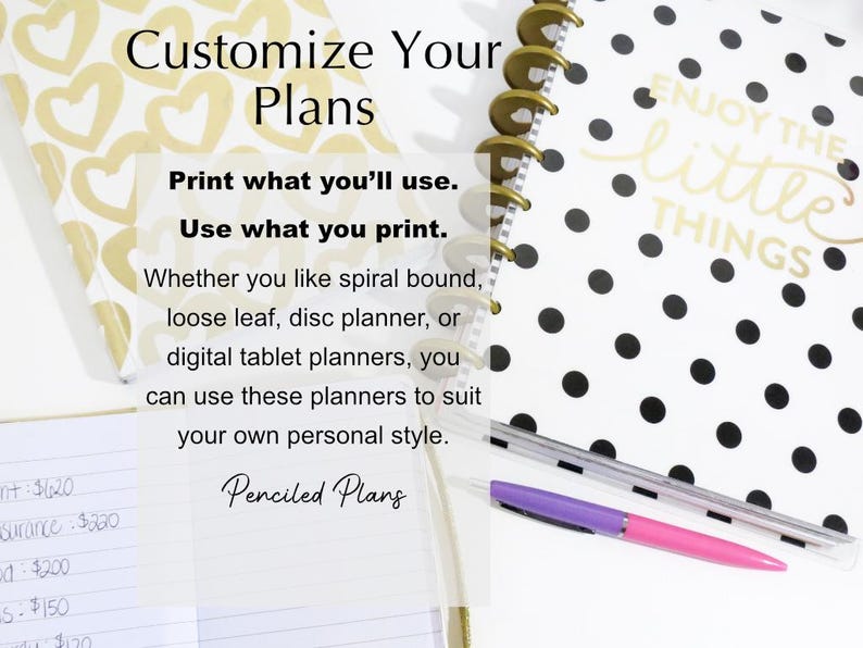 May include: A white planner with black polka dots and the text "Enjoy the little things". The planner has a gold coil binding and is lying on a white surface with a purple pen.