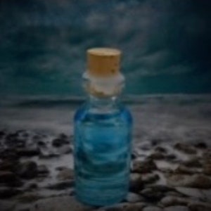 May include: A small, clear glass bottle with a cork stopper. The bottle is filled with a light blue liquid. The bottle is sitting on a rocky beach.