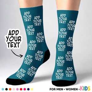 May include: A pair of teal crew socks featuring a repeating white pattern of the text "ADD YOUR TEXT" across the fabric. The socks have solid black toe and heel sections. A separate graphic element displays the text "ADD YOUR TEXT" with an arrow.