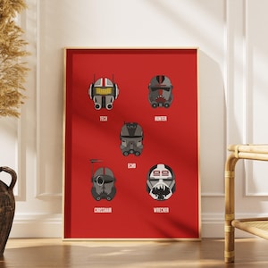 May include: A framed poster featuring six stylized illustrations of helmets against a red background. Each helmet is a different design, with names like "TECH" and "WRECKER" below. The poster is displayed in a room with a vase of dried plants.