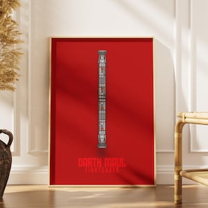May include: A framed poster featuring a lightsaber design against a red background. The lightsaber is silver and gray with red accents. The text "Darth Maul Lightsaber" is at the bottom in white.