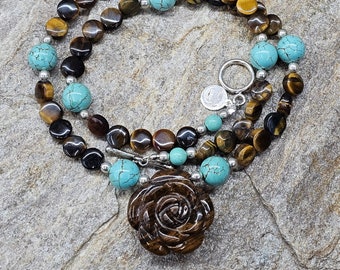 Southwest beaded necklace! Carved tiger's eye floral focal bead, tiger's eye disc, round turquoise colored howlite, sterling silver.