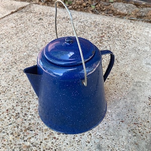 May include: A set of three ceramic nesting bowls in shades of blue, green, and white. The bowls feature a speckled glaze and a simple, modern design. The largest bowl is approximately 6 inches in diameter.