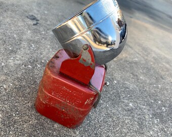 May include: A vintage Justrite lantern, featuring a red base and a chrome reflector. The base is rectangular and shows the text "Justrite Chicago Ill.". The metal components show signs of age and wear.