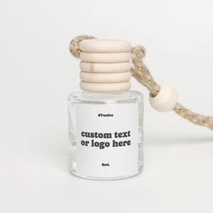 May include: Clear glass bottle with a wooden cap and a rope. The bottle has a white label with the text "custom text or logo here" and "8mL". The bottle is designed to be hung.
