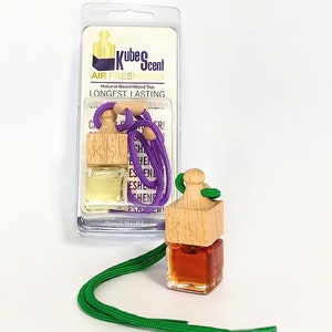 May include: A wooden car air freshener with a purple string and a small glass bottle filled with liquid. The packaging says "Kube Scent Air Freshener Natural Beech Wood Top Longest Lasting".