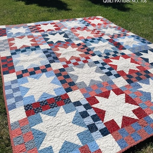 May include: A quilt featuring a repeating pattern of white stars set against a background of red, white, and blue checkered squares. The text 'doman design' and 'BETTY QUILT PATTERN NO. 106' is printed in the upper corners of the image.
