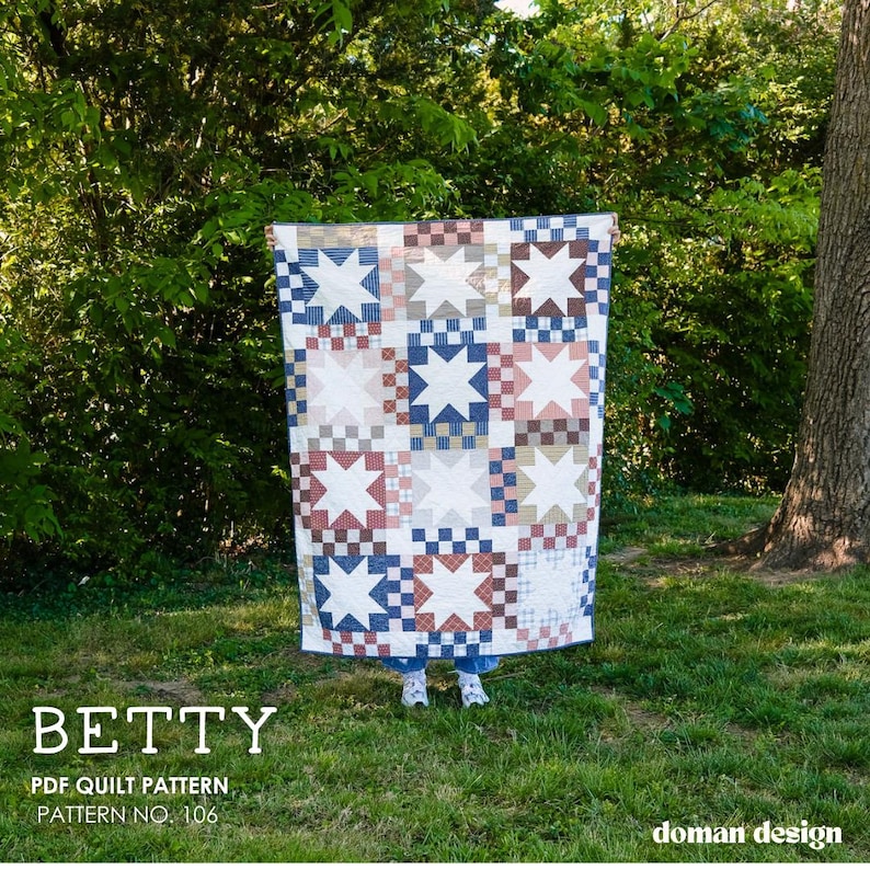 May include: A quilt featuring a repeating star block pattern in shades of blue, red, and white. The design includes checkered border squares and solid white star centers. Text on the image reads: BETTY PDF QUILT PATTERN PATTERN NO. 106.