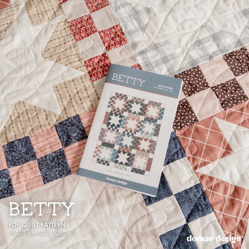 May include: A quilt pattern booklet titled BETTY, Pattern No. 106, featuring a star and checkerboard design in muted tones of red, blue, and cream. The booklet rests on a matching patchwork quilt with quilted star motifs and fabric squares.