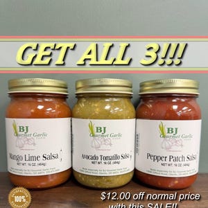 May include: Three glass jars of salsa with gold lids. The jars are labeled "Mango Lime Salsa", "Avocado Tomatillo Salsa", and "Pepper Patch Salsa". The jars are all from BJ Gourmet Garlic Farm. The text "GET ALL 3!!!" is at the top of the image. The text "$12.00 off normal price with this SALE!!" is at the bottom of the image.