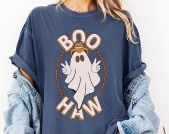 May include: A navy blue t-shirt with a white ghost wearing a cowboy hat and the text "BOO HAW" in brown lettering.