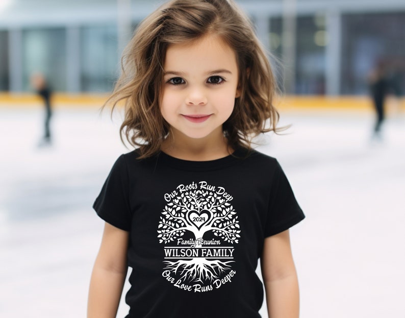 May include: A black t-shirt with a white tree design. The tree has a heart in the center with the year 2023 inside. The text "Our Roots Run Deep" is above the tree, "Family Reunion" is below the tree, and "WILSON FAMILY" is in the center of the tree. The text "Our Love Runs Deeper" is below the roots.