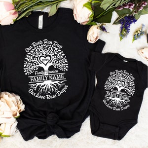 May include: Black t-shirt and onesie with a white family tree design. The tree has a heart in the center with the year 2024 inside. The text reads "Our Roots Run Deep", "Family Reunion", "FAMILY NAME", and "Our Love Runs Deeper".