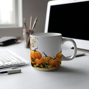 May include: White ceramic mug with a fall-themed design featuring orange pumpkins and green leaves.