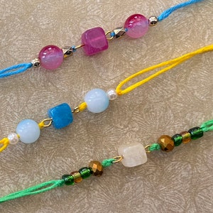 Nature&#39;s Embrace: Designer Rakhis with Natural Stone Centerpiece