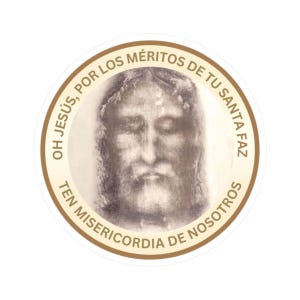 May include: A circular sticker with a sepia-toned image of a face, possibly religious. The image is framed by a brown border with Spanish text: "OH JESÚS, POR LOS MÉRITOS DE TU SANTA FAZ TEN MISERICORDIA DE NOSOTROS."