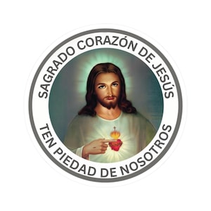 May include: A circular sticker with an image of Jesus, with long brown hair and a beard. The text "SAGRADO CORAZÓN DE JESÚS TEN PIEDAD DE NOSOTROS" is in a circular border. Jesus is shown with the Sacred Heart on his chest.