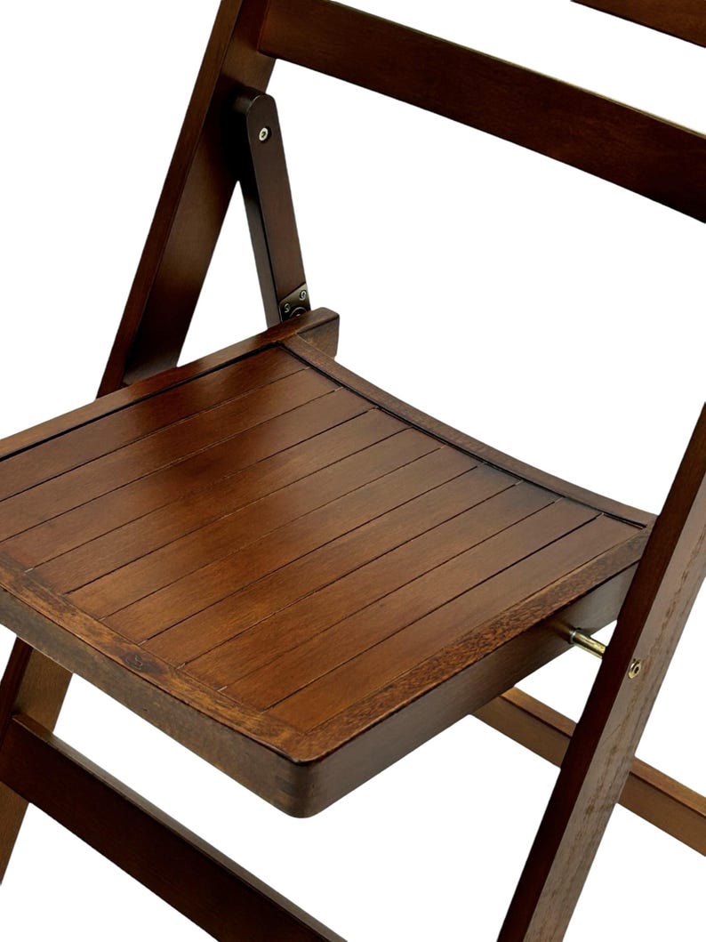 May include: A dark brown wooden folding chair with a slatted seat and a simple design. The chair is made of solid wood and has a sturdy construction.