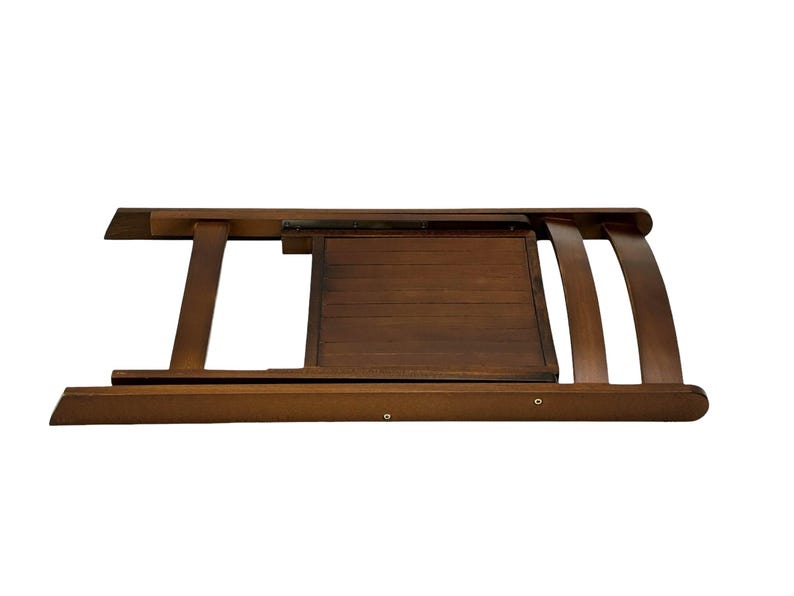 May include: A brown wooden folding chair with a slatted back and seat. The chair is folded and the seat is facing up.