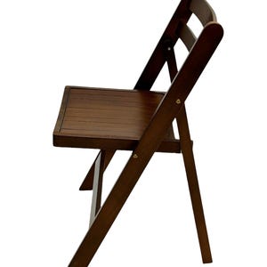 May include: A dark brown wooden folding chair with a slatted seat and a curved back.