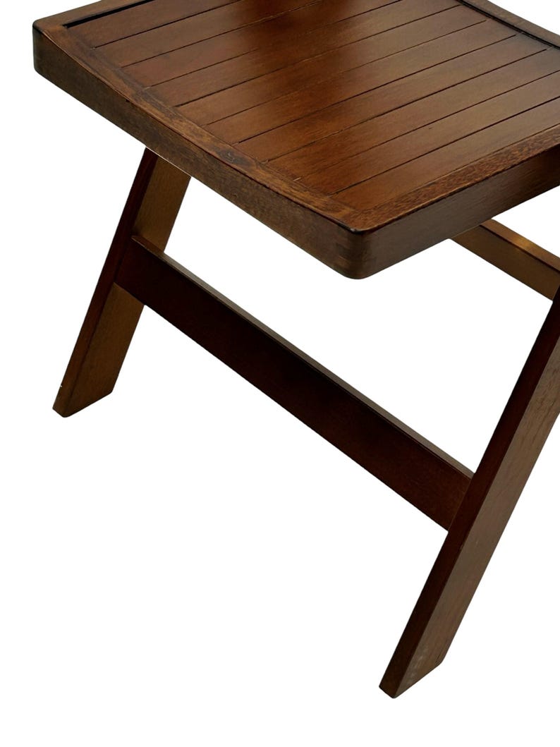 May include: A dark brown wooden folding chair with a slatted seat and a simple, sturdy design.