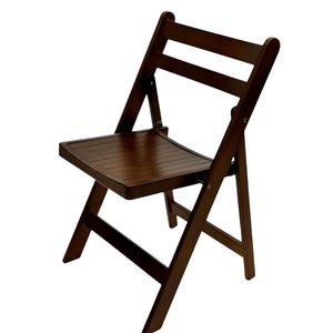 May include: A dark brown wooden folding chair with a slatted seat and back.