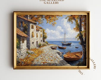 May include: A framed landscape painting depicts a coastal scene with buildings, boats, and a cobblestone path. The artwork features a golden frame and the text "THE SEASONED GALLERY". The painting showcases a serene view of the sea and sky.