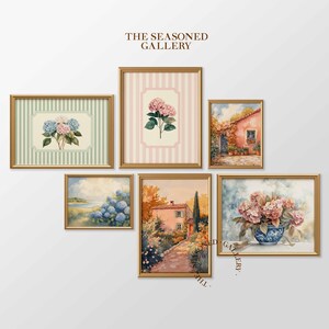 May include: A collection of framed art prints featuring floral and landscape watercolor paintings. The prints include images of hydrangeas, a European villa, and a coastal scene. The frames are gold-colored and the background is white. The text "THE SEASONED GALLERY" is visible.