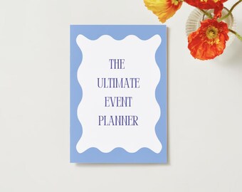 May include: A light blue planner with a white border and the text "THE ULTIMATE EVENT PLANNER" in navy blue.
