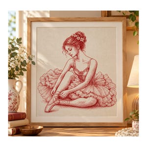 Peut inclure: Une illustration encadrée à l'encre rouge représentant une ballerine assise qui noue les rubans de ses chaussons de danse. La danseuse porte un tutu à volants et ses cheveux sont relevés en chignon orné de petites fleurs.