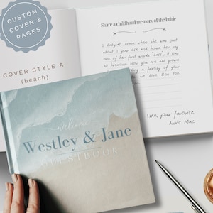 May include: A light blue and beige watercolor-style wedding guest book with the text "Welcome Westley & Jane GUESTBOOK" on the cover.