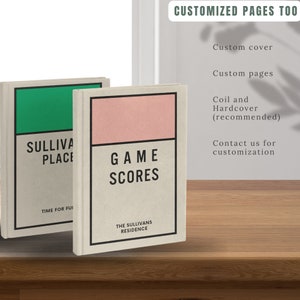 May include: Two hardcover journals with custom covers. The left journal has a green cover with the text "SULLIVAN PLACE" and "TIME FOR FUN". The right journal has a pink cover with the text "GAME SCORES" and "THE SULLIVANS RESIDENCE".