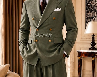 May include: A sage green double-breasted suit with gold buttons, a white pocket square, and a brown tie. The suit is paired with wide-leg trousers. The image includes the text "MAANMUK Dress to Succeed".