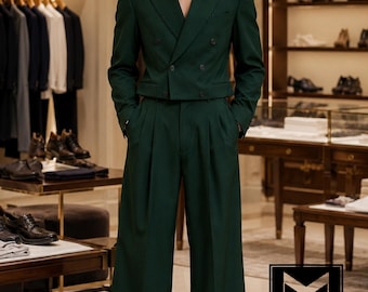 May include: A dark green double-breasted cropped blazer with notched lapels and matching high-waisted wide-leg trousers. The ensemble features dark buttons and a clean, tailored silhouette. A logo with the text MAANMUK Dress to Succeed is visible.