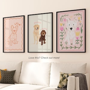 May include: Three framed illustrations of dogs. The first frame is pink with a white dog with the name "BAMBA" in orange text. The second frame is light blue with a brown dog with the name "COOPER" in orange text. The third frame is pink with a white dog with the name "LYLA" in orange text.
